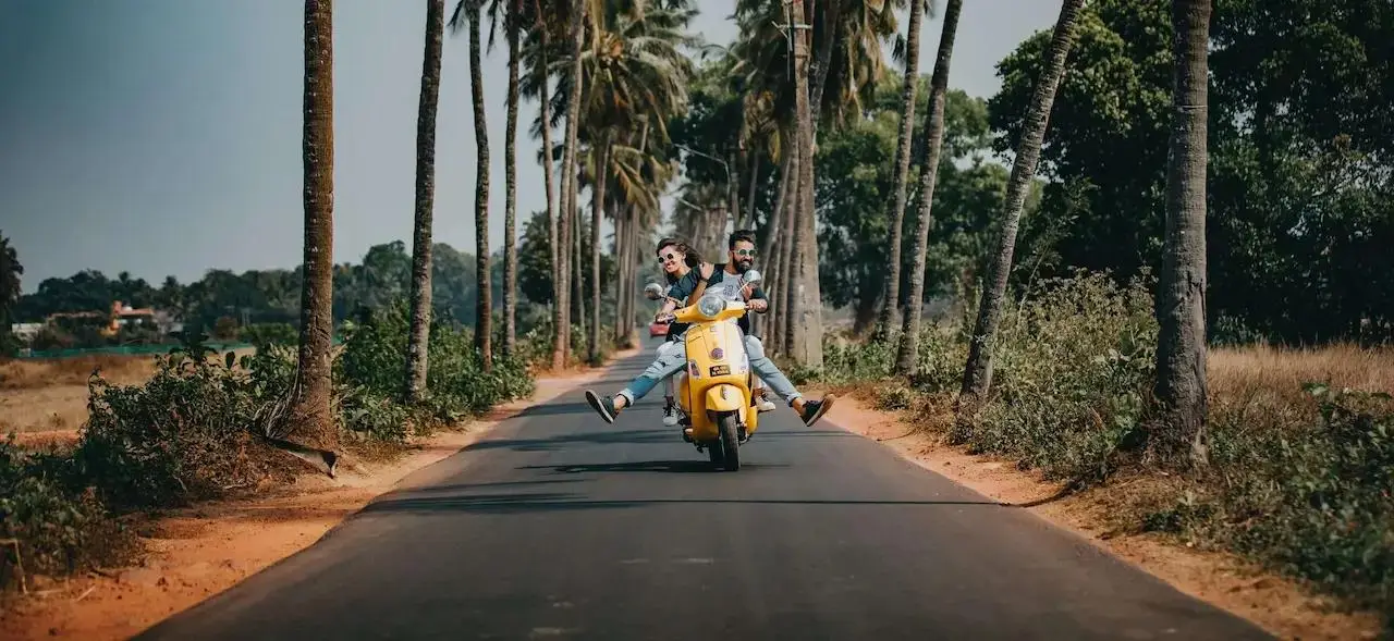Couple riding scooter