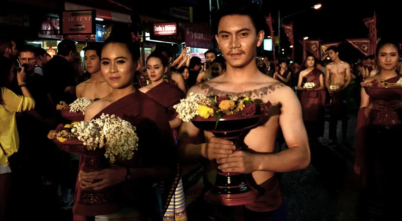 Dancers in traditional Lanna dress carrying flowers in the Loy Krathong parade