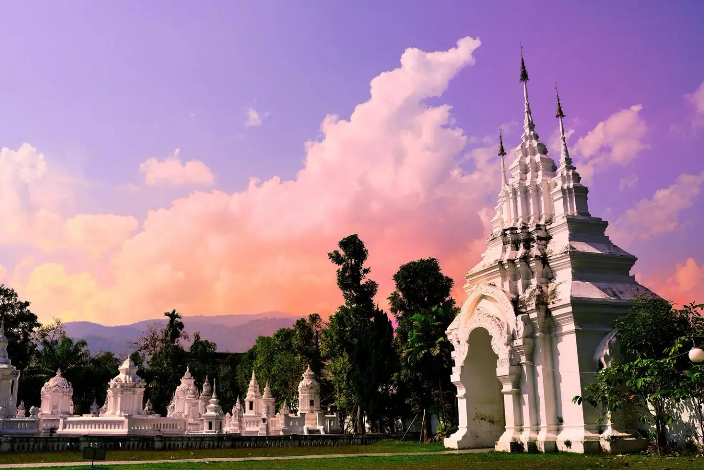 The white chedis of Wat Suan Dok at sunset