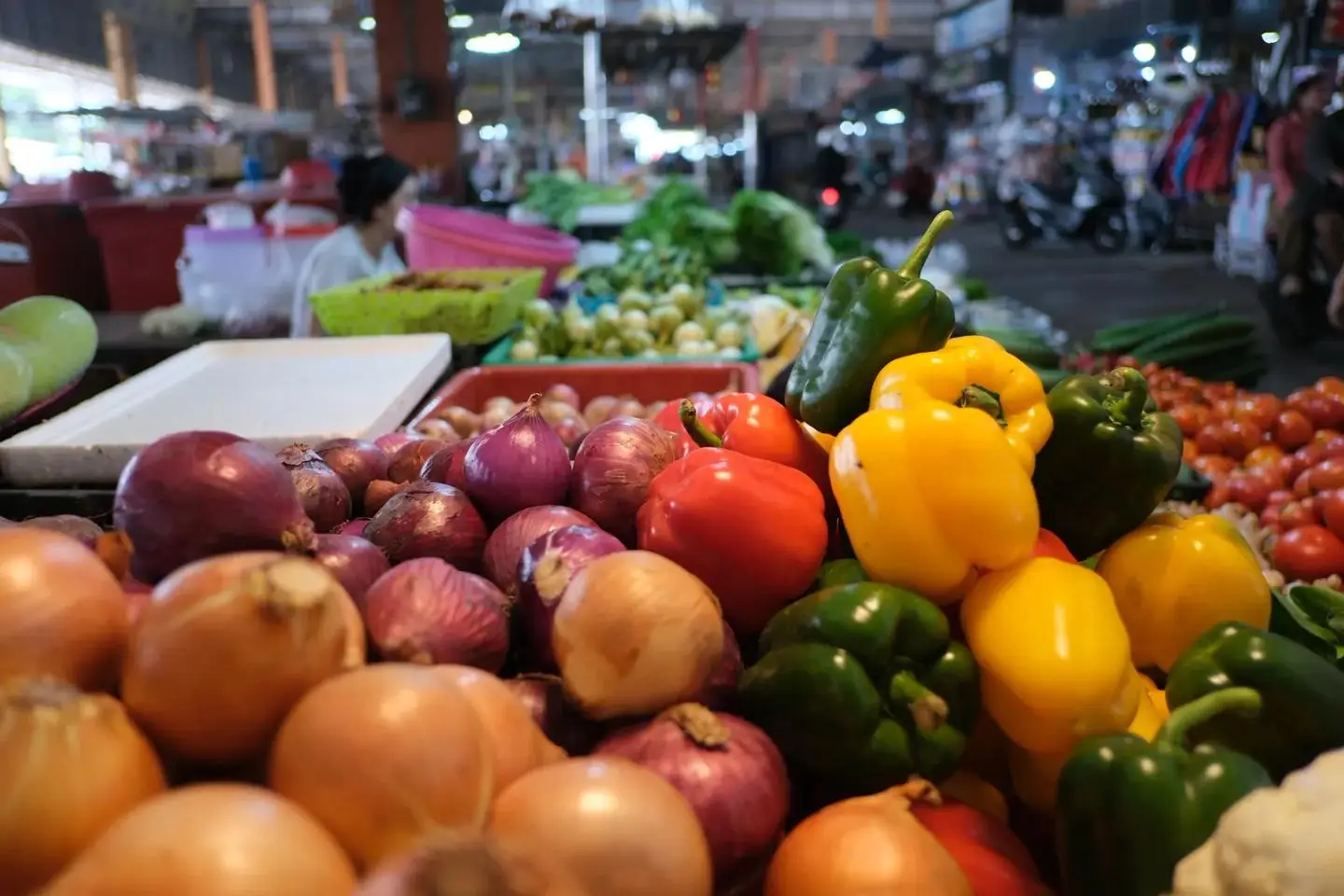 Fresh vegetables piled high at a Thai market stall