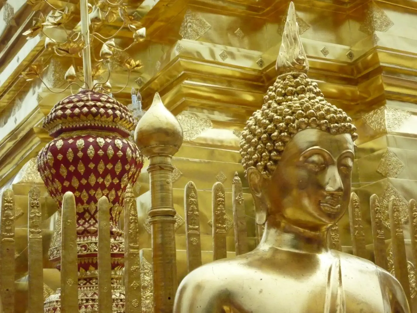 A golden Buddha beside the central chedi at Doi Suthep